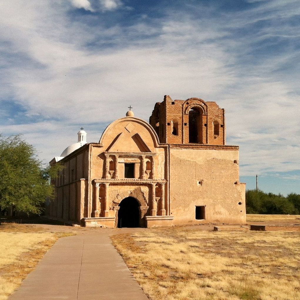 A large brick building with a walkway leading to it