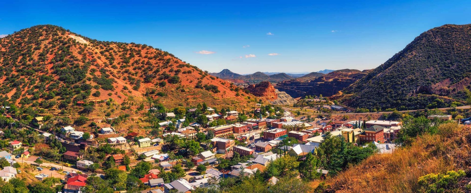An aerial view of a small town surrounded by mountains.