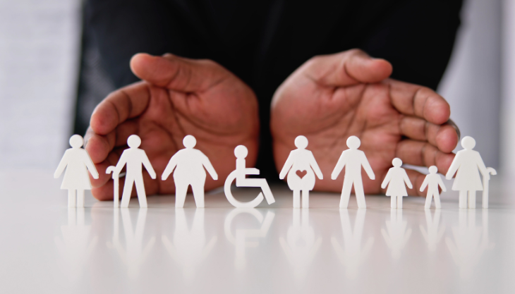 A person displays a diverse set of paper people to symbolize diversity and inclusion best practices