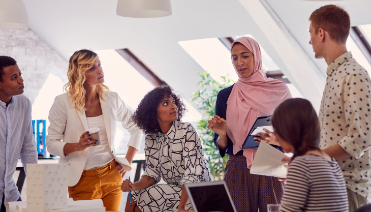 team of diverse individuals discussing religious accommodation policies in the workplace