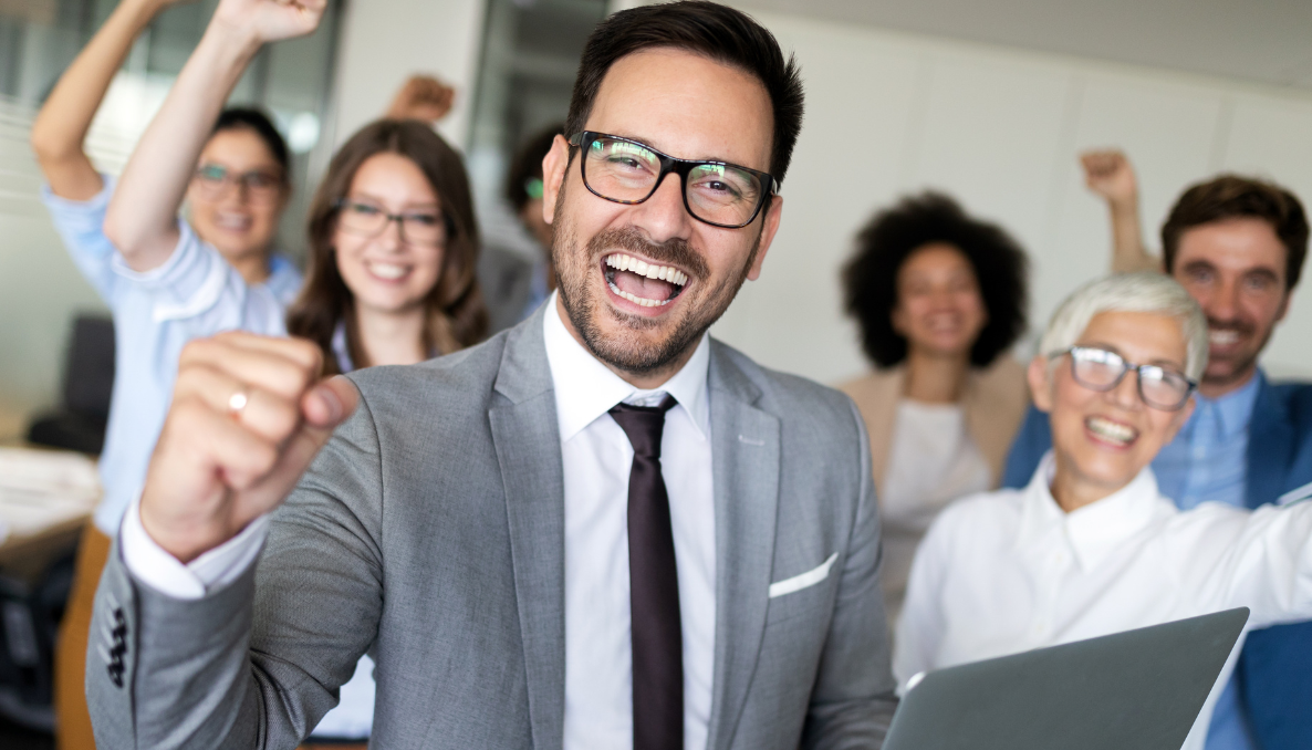 A company's diverse staff celebrate shared success with diversity and inclusion at work