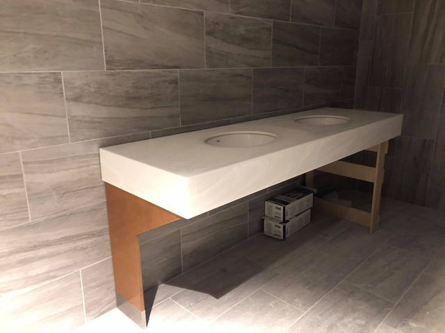 A bathroom with two sinks and a wooden table.