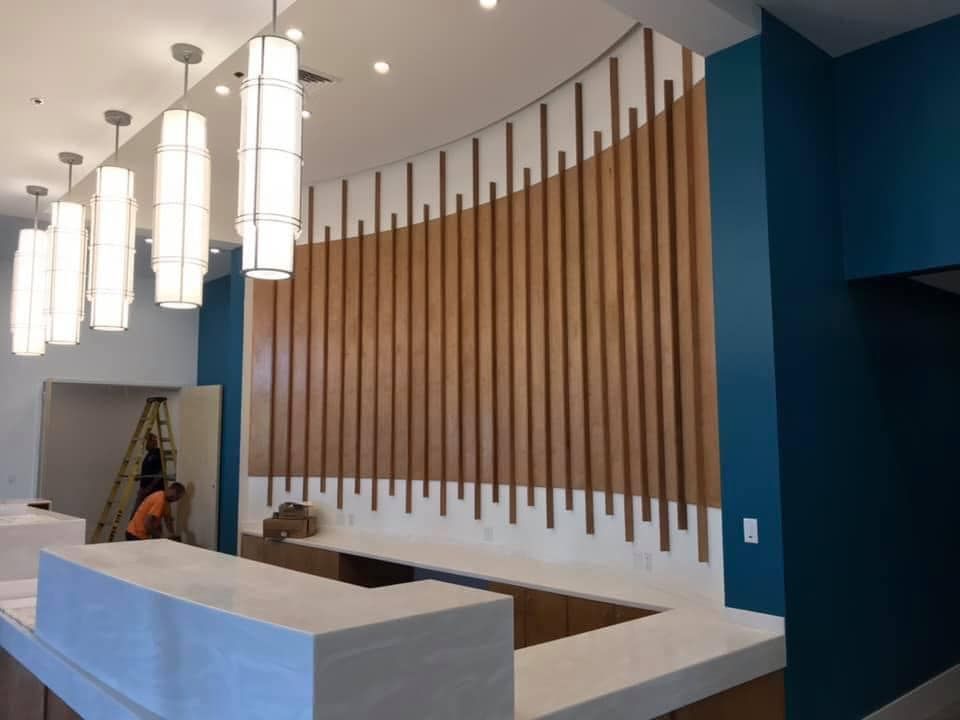 A reception desk with a wooden wall behind it