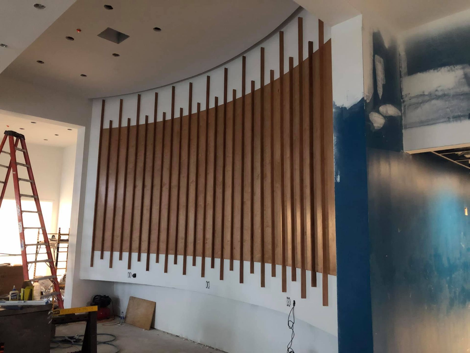 A room with a large wooden wall and a ladder