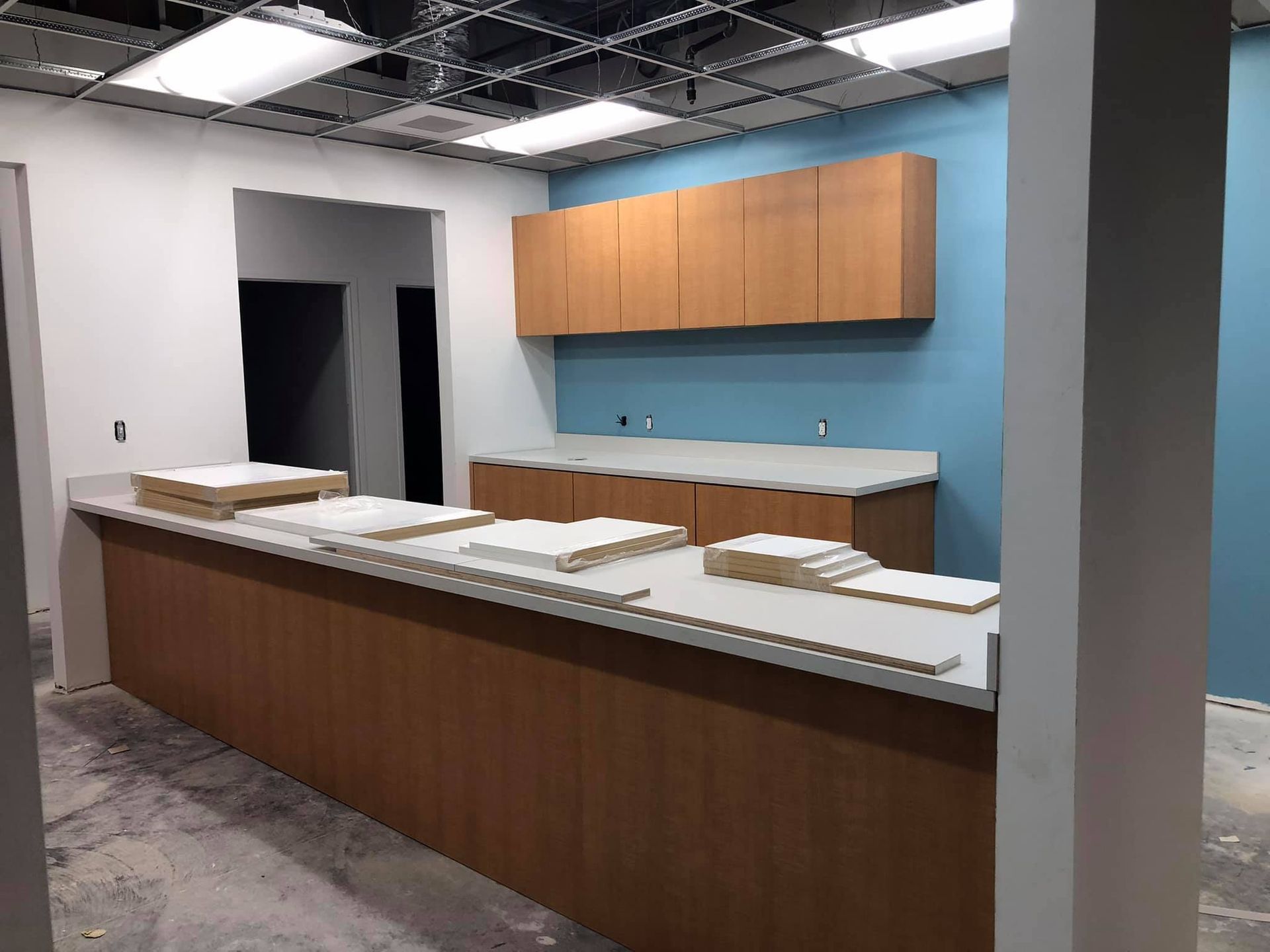 A kitchen under construction with wooden cabinets and counter tops