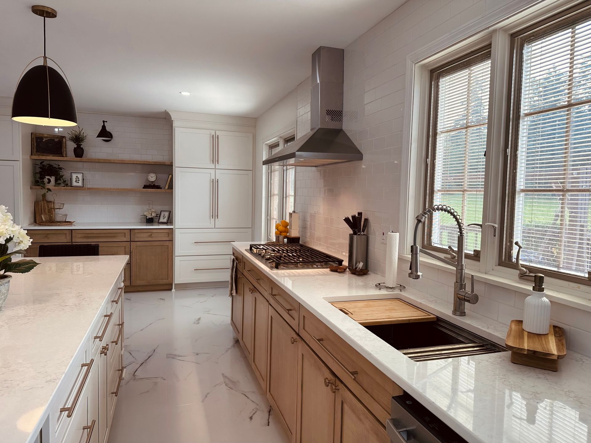 A kitchen with wooden cabinets , white counter tops , a sink and a stove.