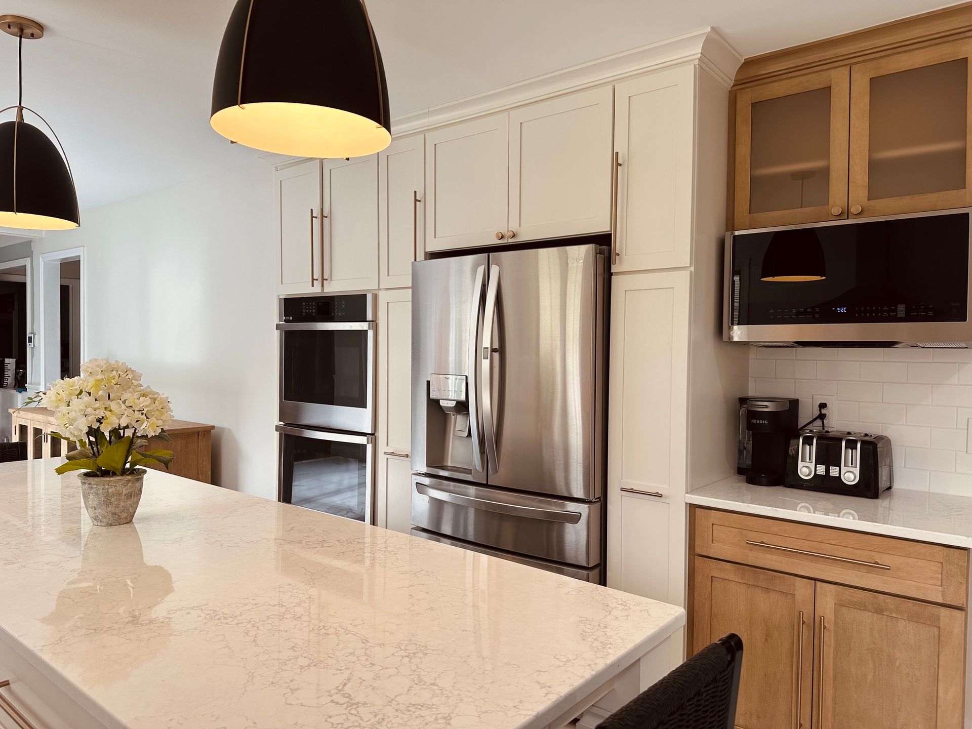 A kitchen with stainless steel appliances and white cabinets.