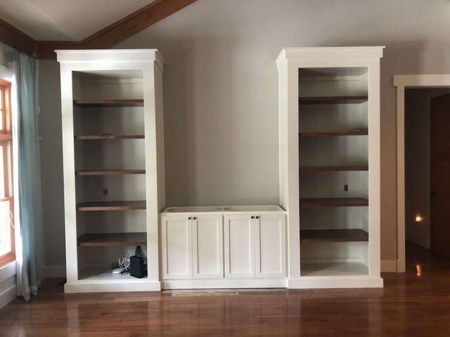 A living room with two shelves and two cabinets