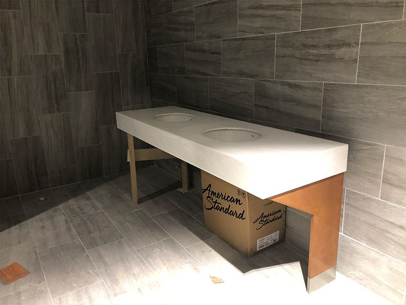 A bathroom with a box that says american standard on it