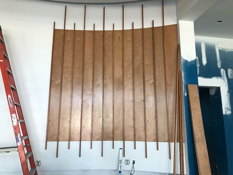 A ladder is leaning against a wall with wooden sticks on it