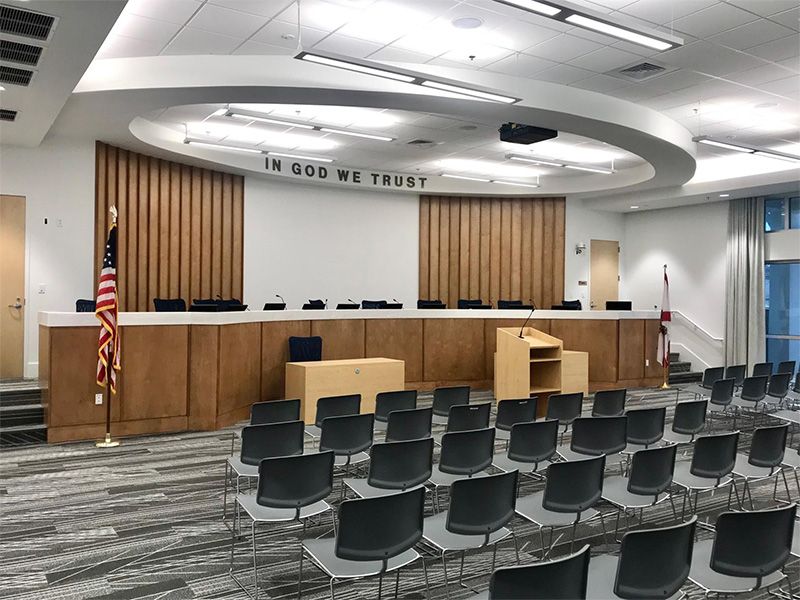 A conference room with rows of chairs and a podium.