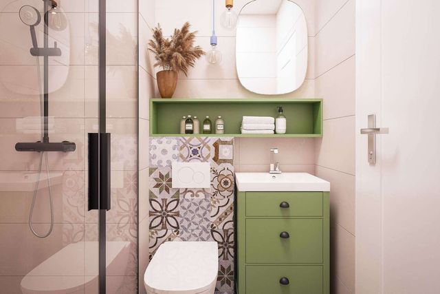 A bathroom with a toilet , sink , mirror and shower.