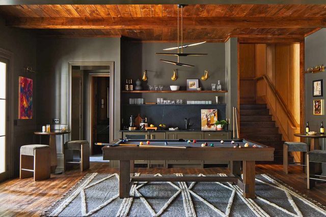 There is a pool table in the middle of the room.