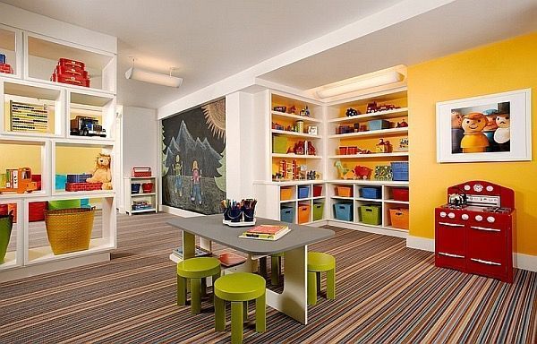 A children 's play room with a table and stools