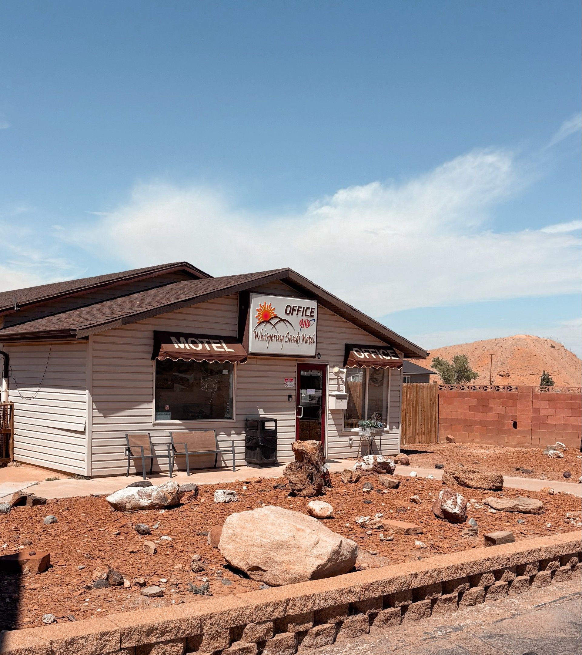 Small roadside shop in a red desert landscape under a blue sky