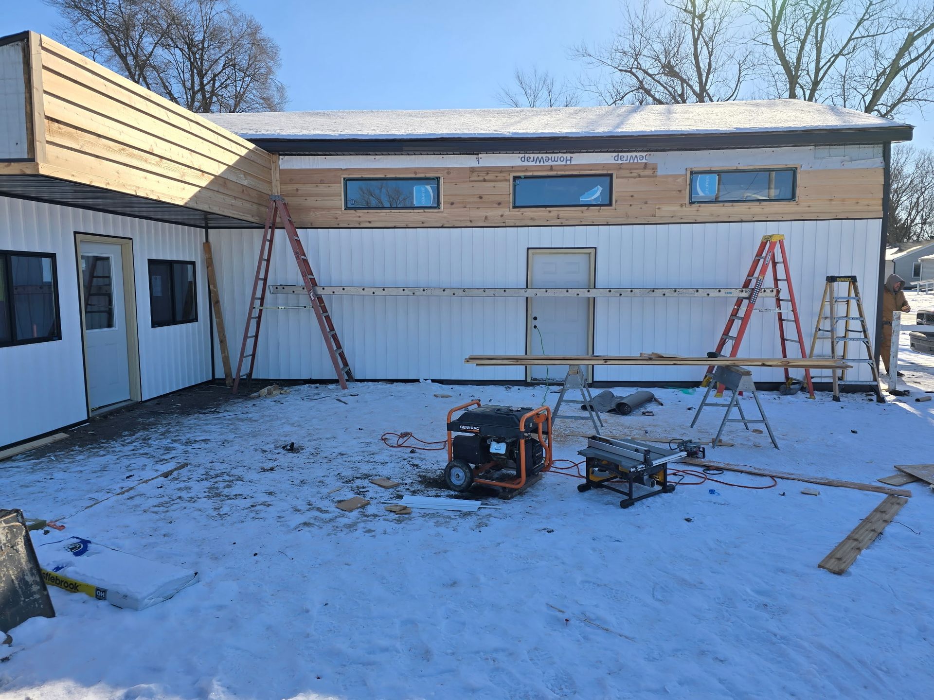 Interior of a garage under construction with wood framing and exposed rafters. Interior of a garage under construction with wood framing and exposed rafters.