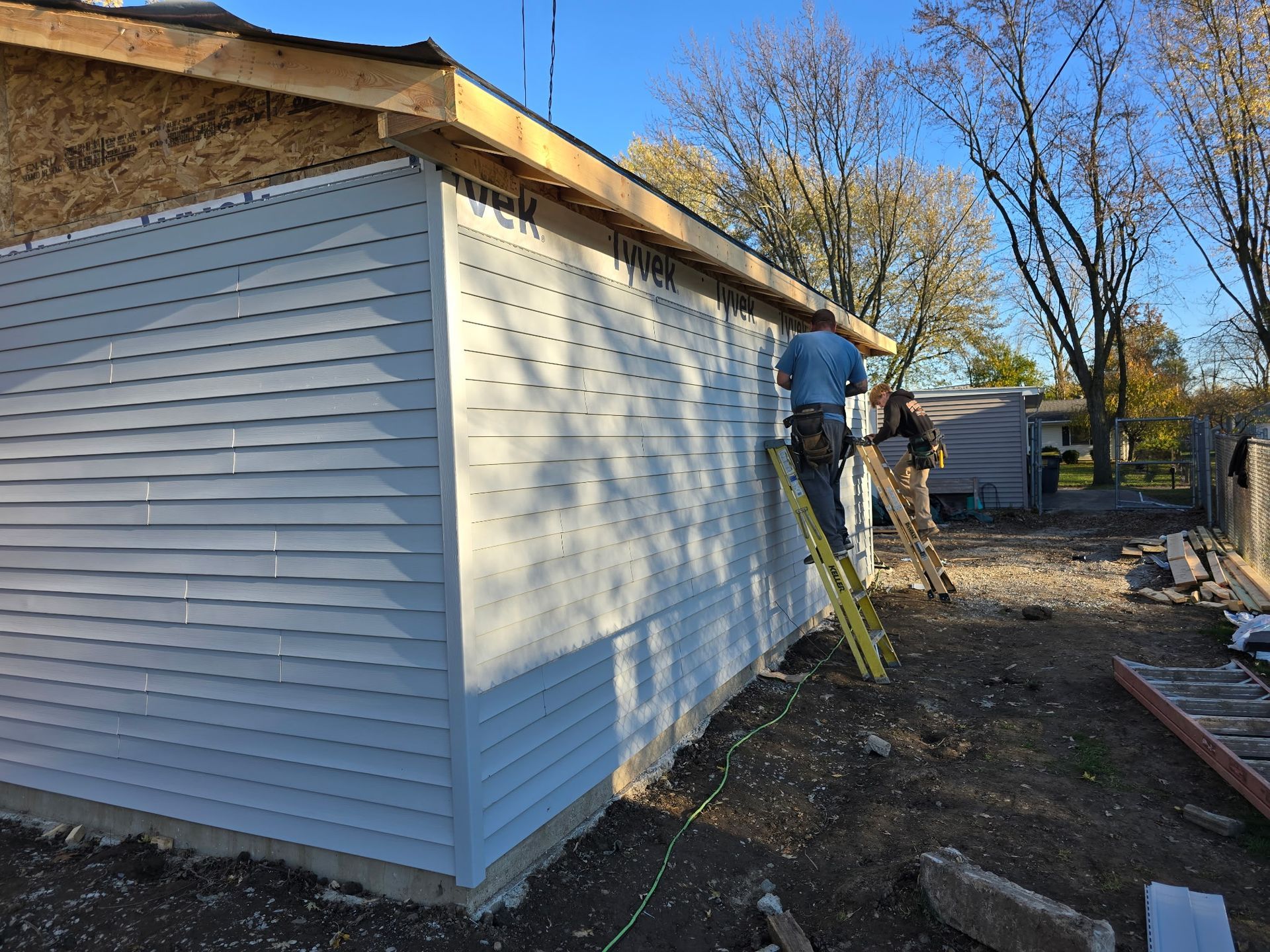 Man reaching toward garage door, partially open. Sunlight from garage illuminates his face and arm. Man reaching toward garage door, partially open. Sunlight from garage illuminates his face and arm.