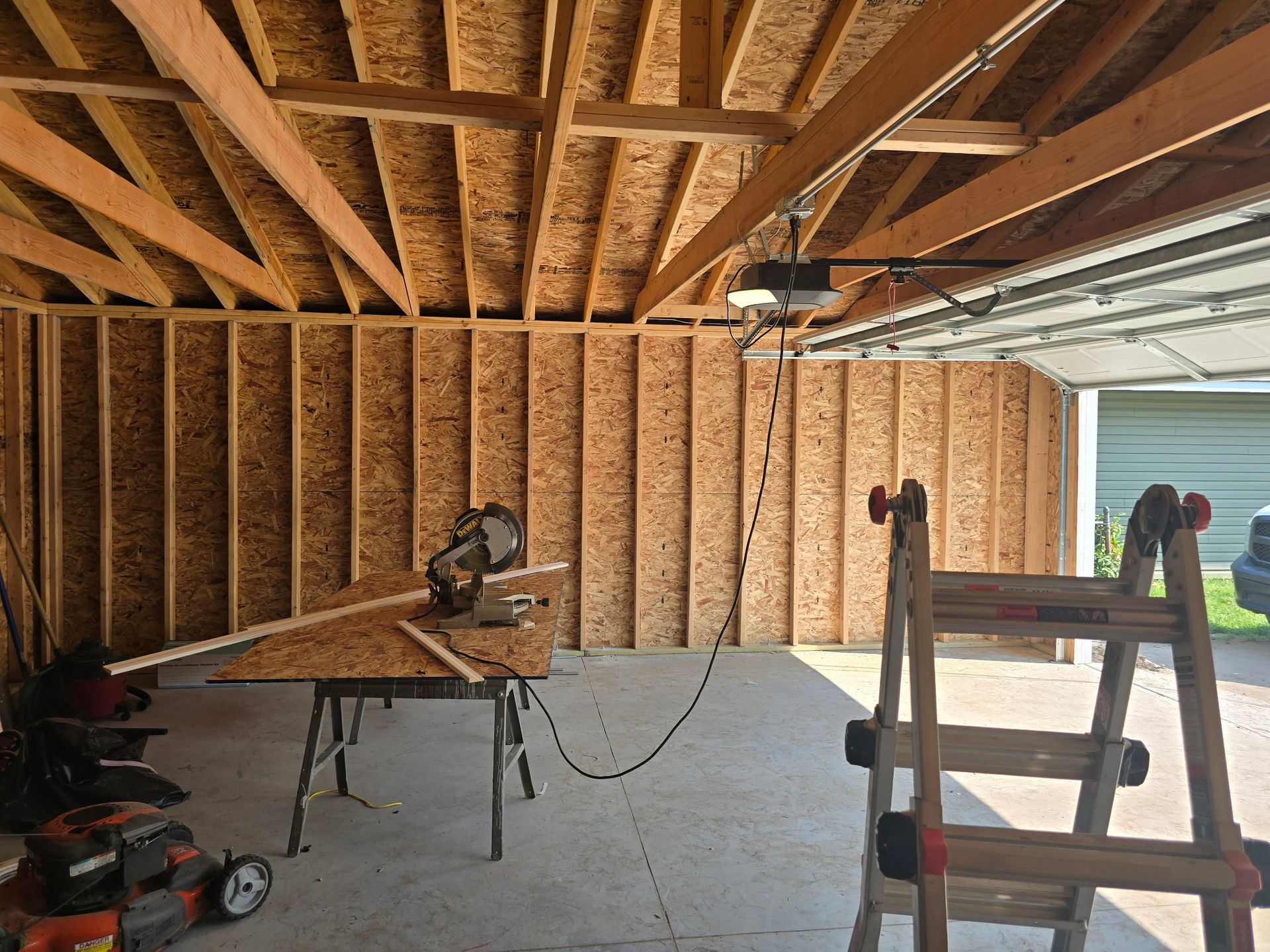 Construction worker in a safety vest and hard hat, looking at blueprints inside a building frame. Construction worker in a safety vest and hard hat, looking at blueprints inside a building frame.