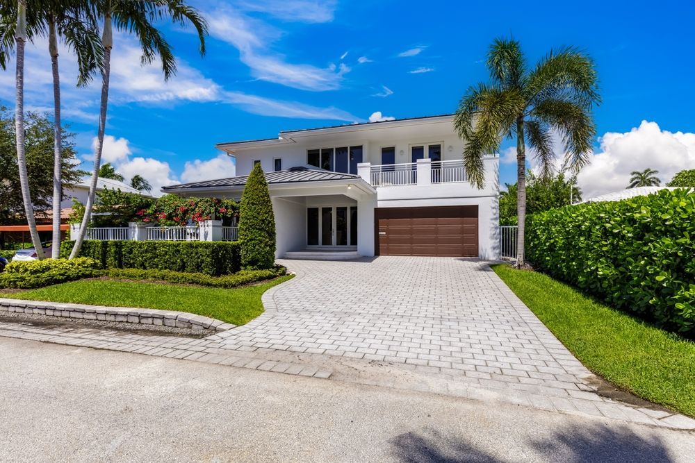 A large white house with a wooden garage door