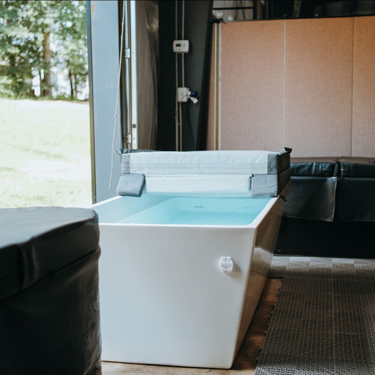 A bathtub is sitting in a room next to a window