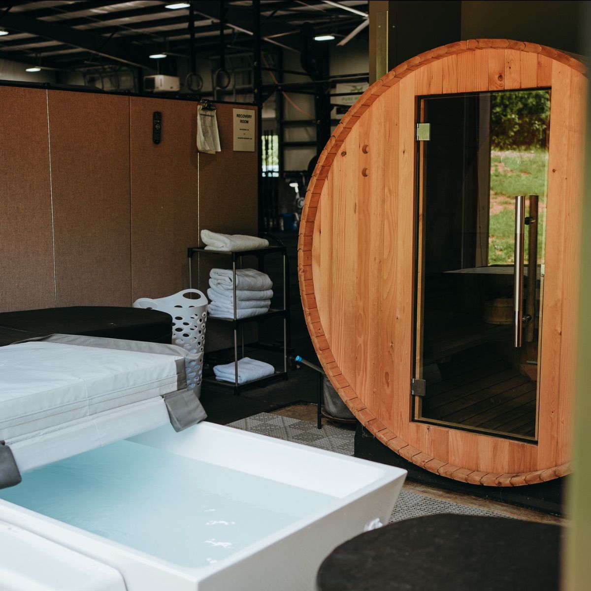 A bathroom with a tub and a wooden sauna