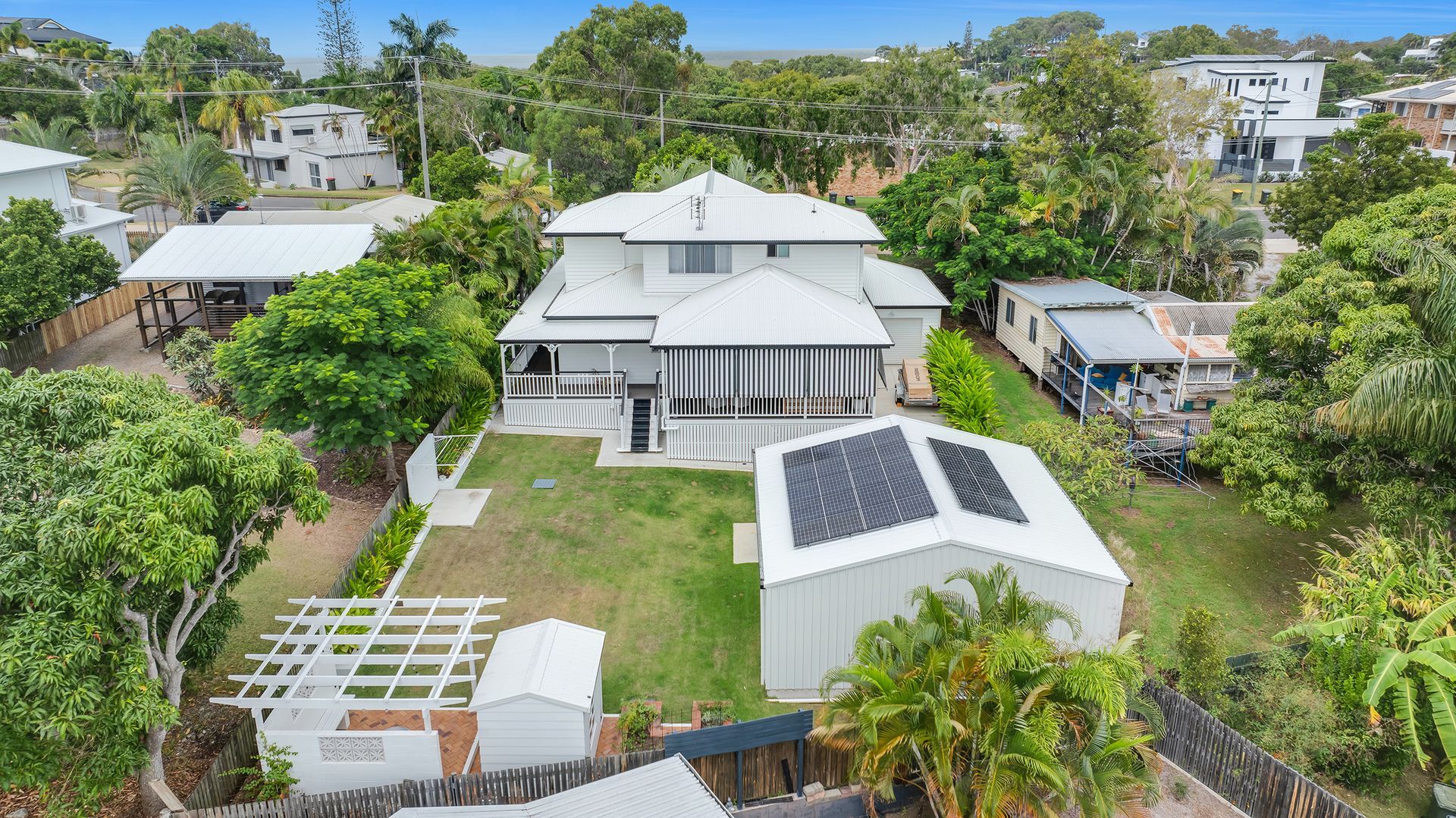 Aerial View of a White Two-story House With Solar Panels — Wares Blinds, Screens & Awnings In Tannum Sands, QLD