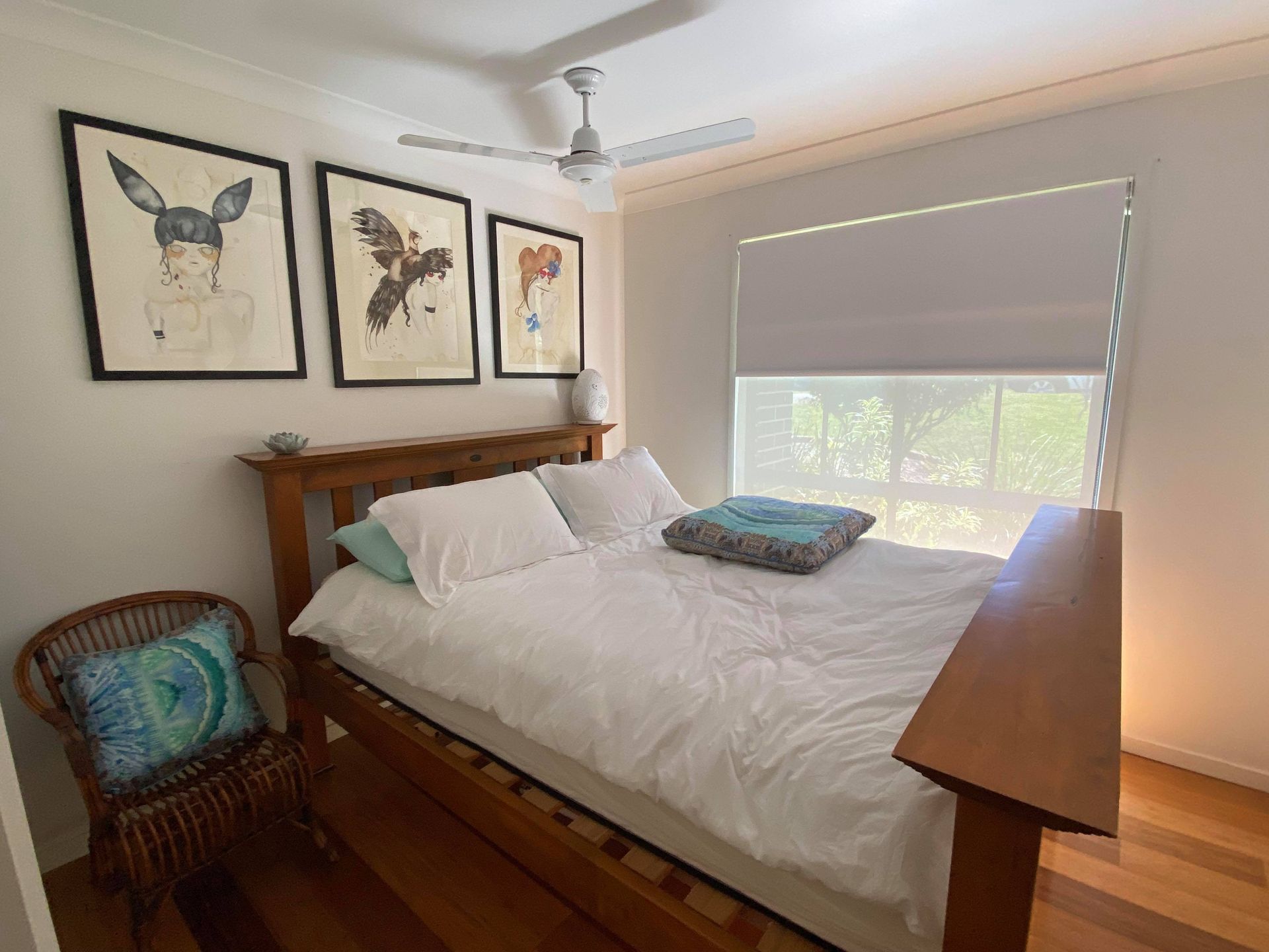 Bedroom with Wooden Bed, Art, and Window with Blinds — Wares Blinds, Screens & Awnings In Gladstone Central, QLD