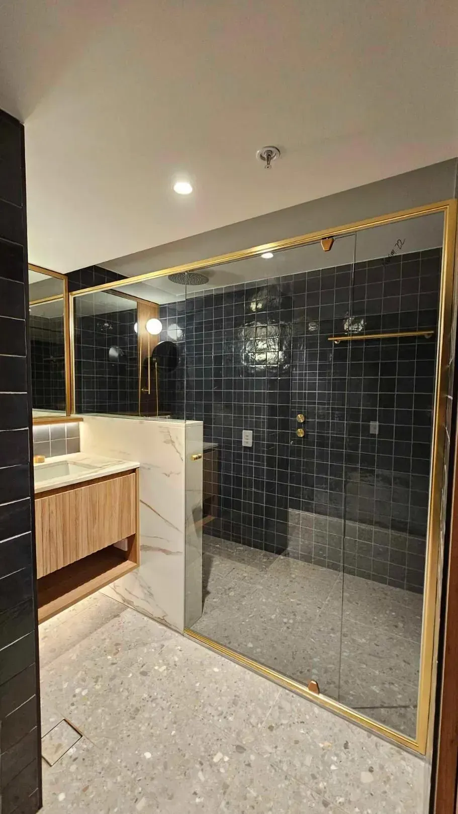 Modern Bathroom: Shower with Gold Frame and Dark Tile, Vanity with Wood Cabinet, Terrazzo Floor — Wares Blinds, Screens & Awnings In Rockhampton, QLD