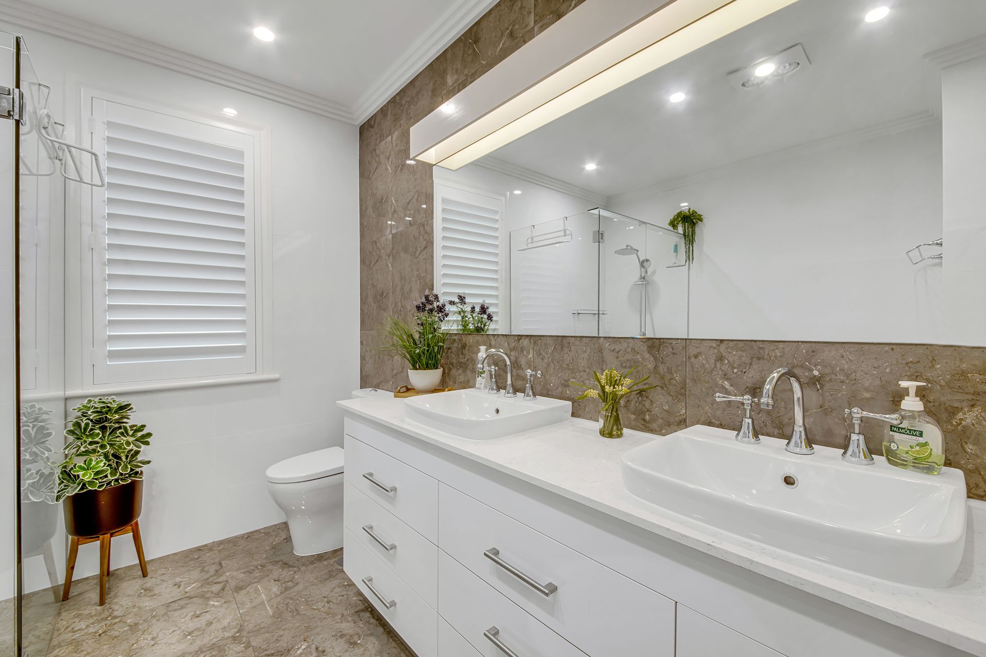 Bathroom With White Vanity, Dual Sinks, Large Mirror, and Window With Shutters — Wares Blinds, Screens & Awnings In Gladstone Central, QLD