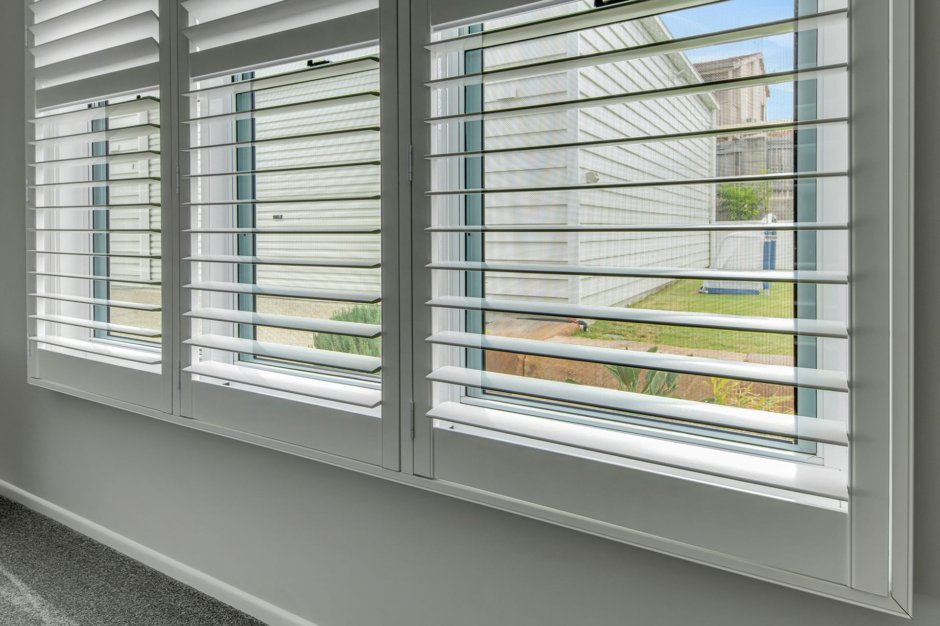 White Window Shutters, Partially Open, Letting in Light — Wares Blinds, Screens & Awnings In Gladstone Central, QLD