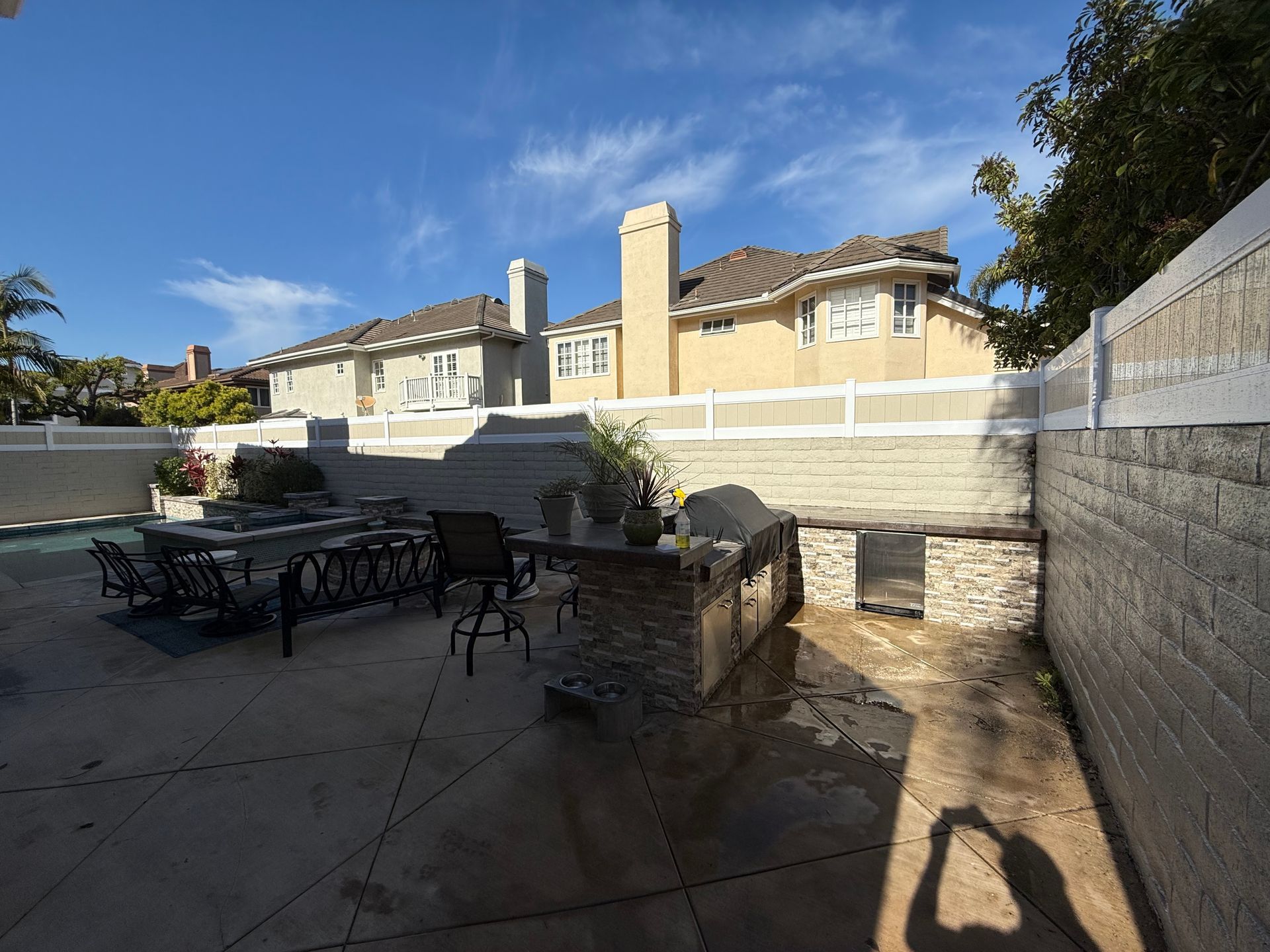 dark grey vinyl fence on top of brick wall