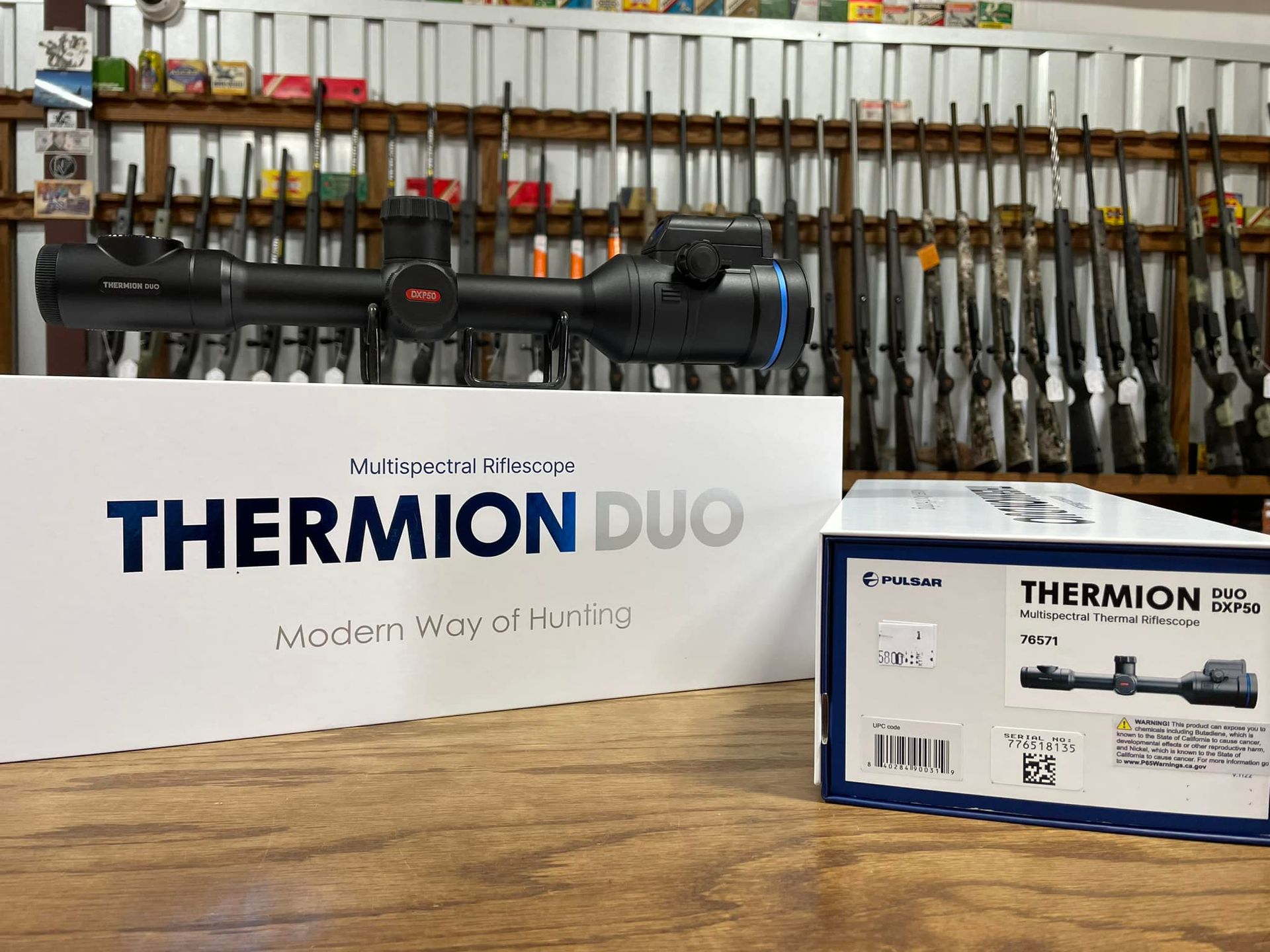 A thermon duo scope is sitting on a wooden table next to a box.