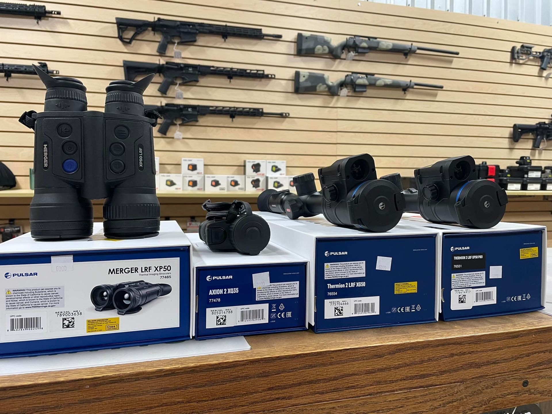 A bunch of binoculars are sitting on a table in a store.
