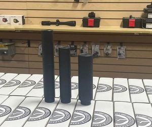 Three black tubes are sitting on a table in a store