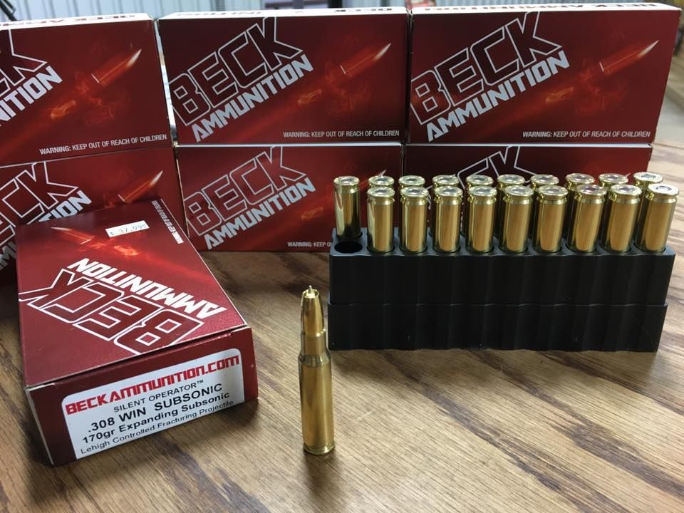 Boxes of beck ammunition are sitting on a wooden table.
