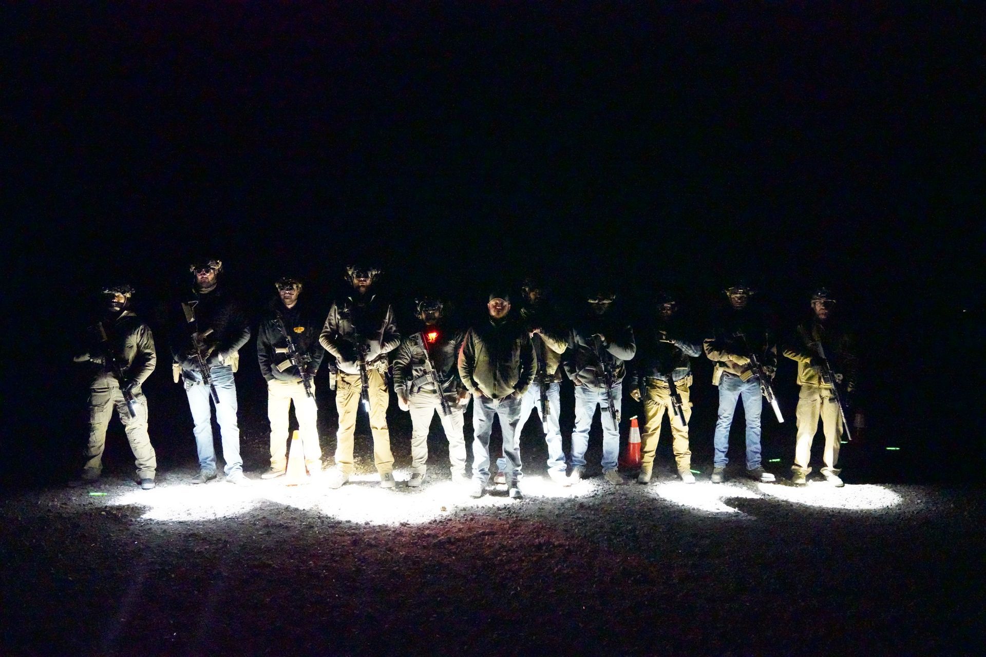 A group of people standing in a line in the dark