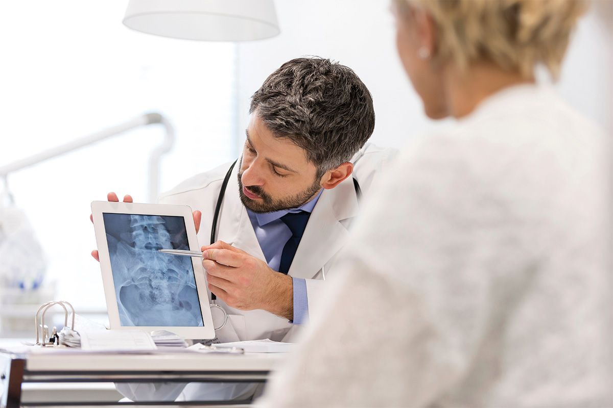doctor going over an x-ray with a patient