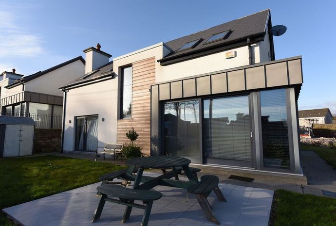 A house with a picnic table in front of it