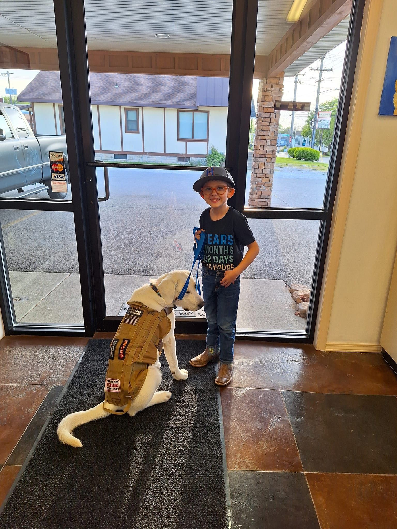A Boy is Standing Next to a Dog Wearing a Jacket | Springfield, MO | MMK9