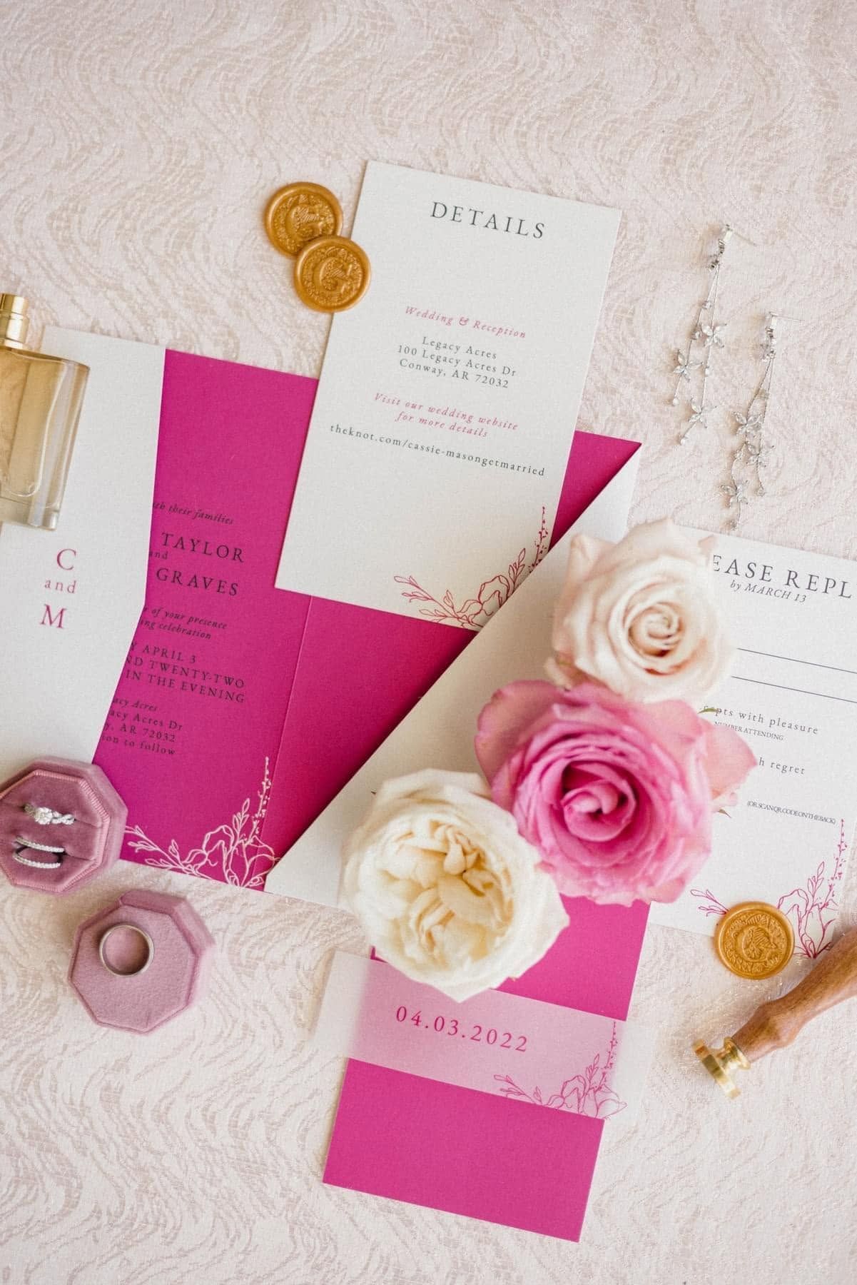 Pink and white floral stationery flat lay with gold coins and paper cards