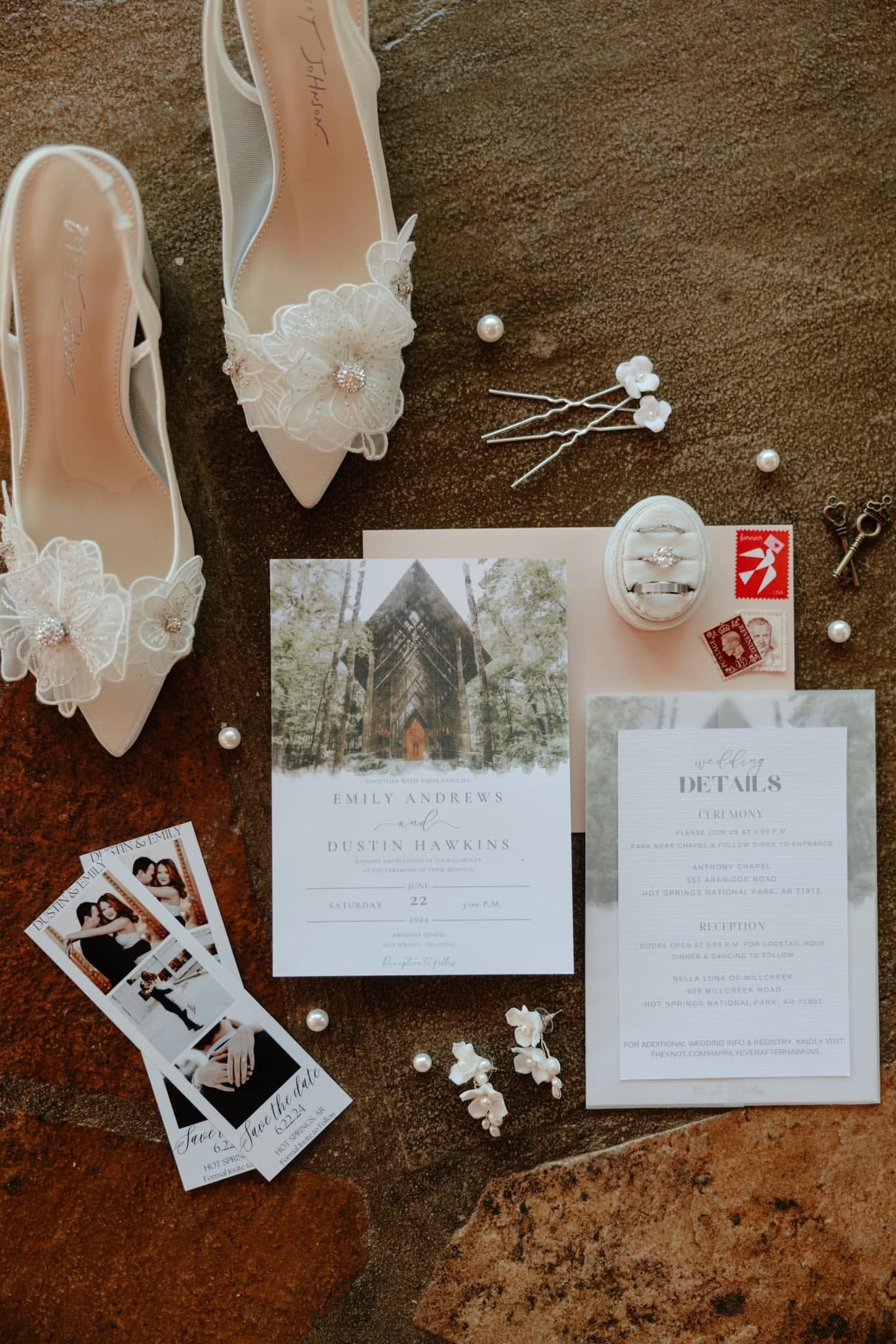 Flat-lay of wedding stationery, a bridal shoe, and printed photos on a brown fur background
