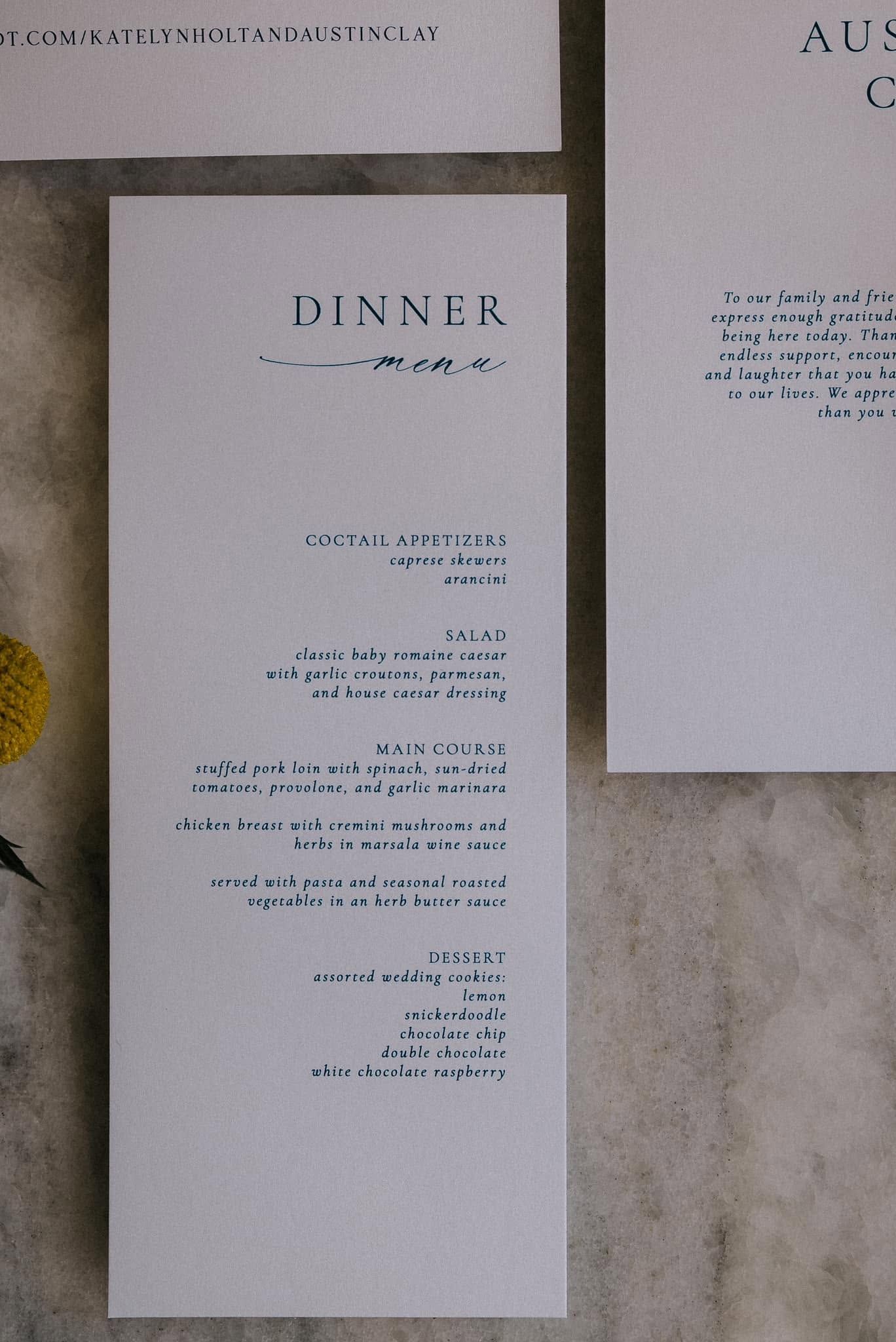 Three white paper menus on a textured beige wall, with one centered and partially readable.