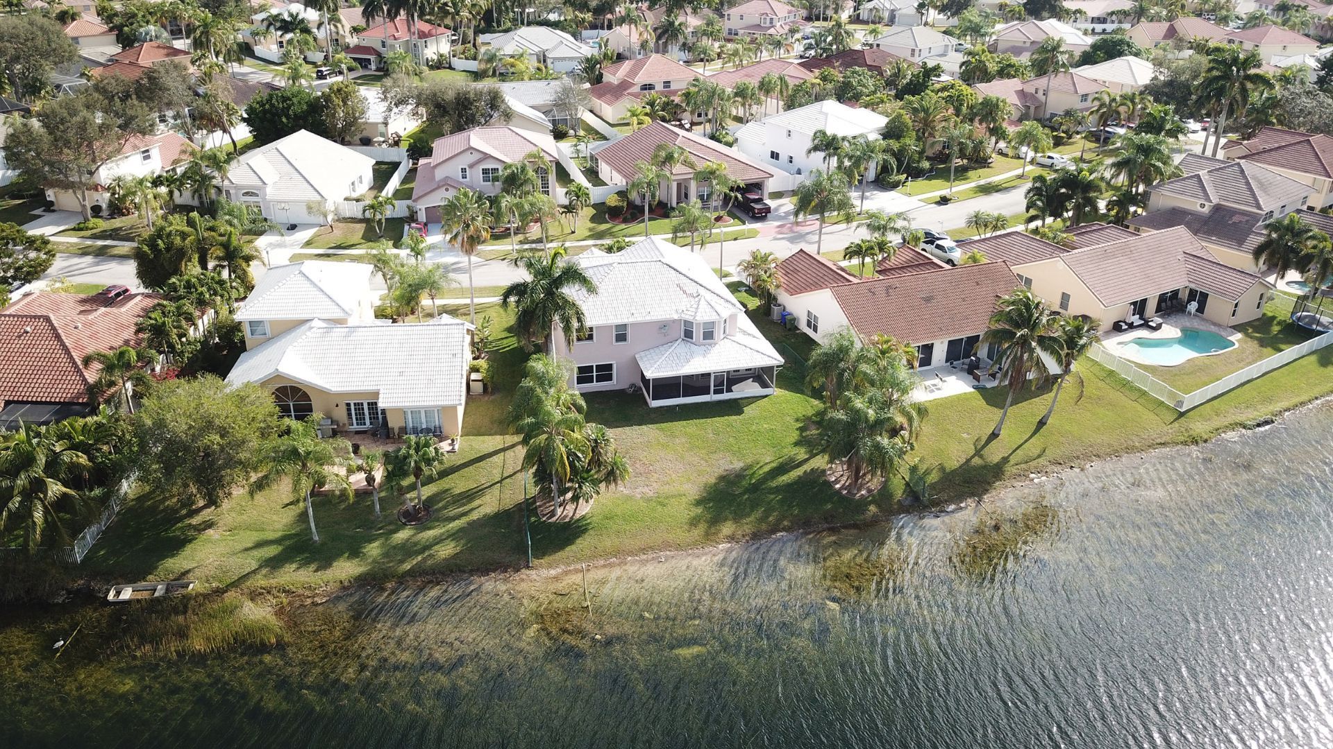 An aerial view of a residential area next to a body of water.