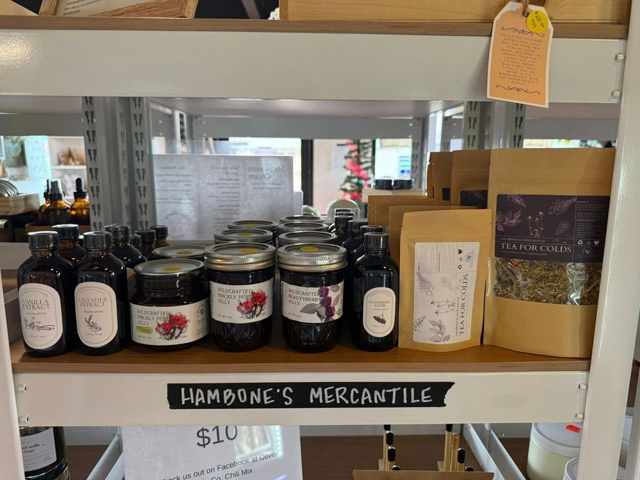 Shelves displaying various jars and bottles of products in a store labeled