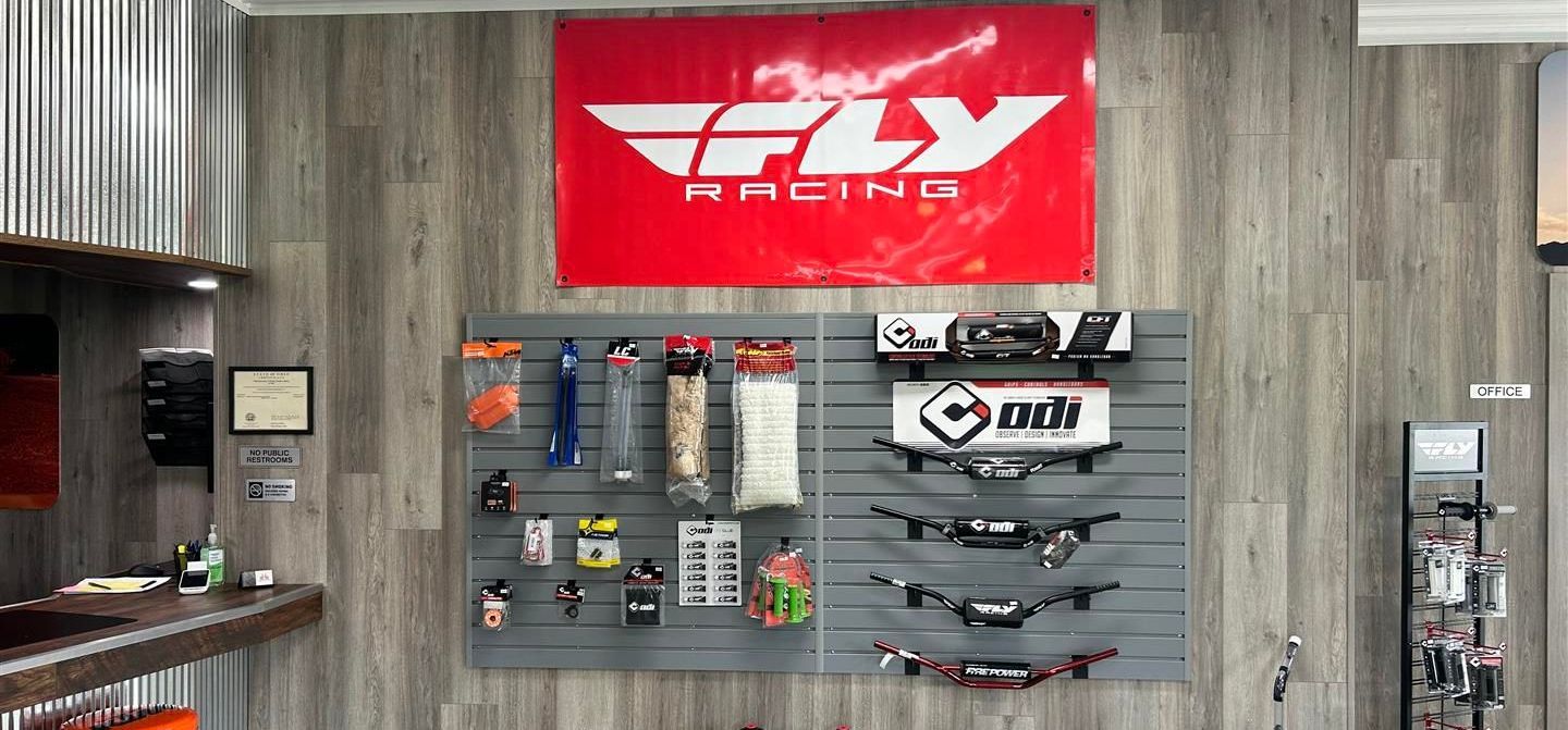 Motorcycle parts displayed in a shop, with a red and white
