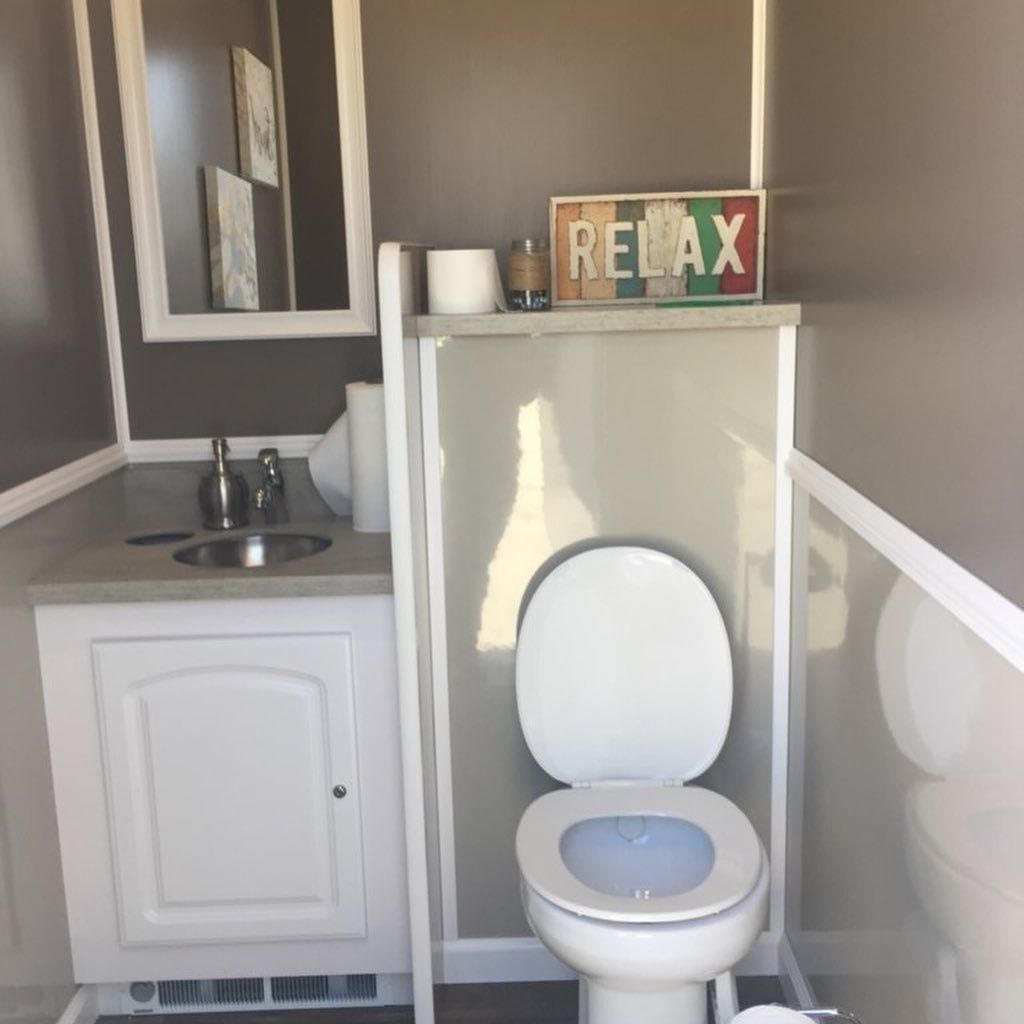 A bathroom with a toilet and a sign that says relax