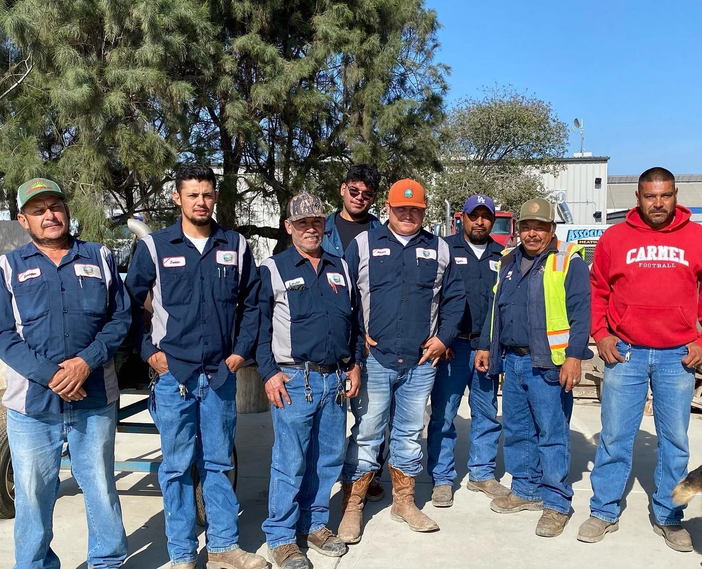 A group of construction workers are posing for a picture.