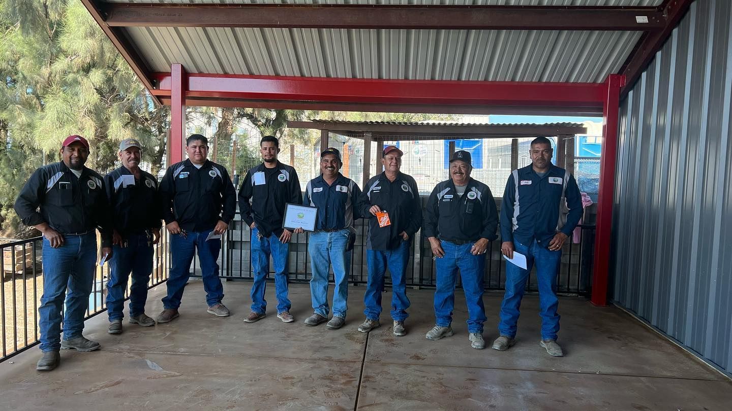 A group of men standing next to each other under a roof.