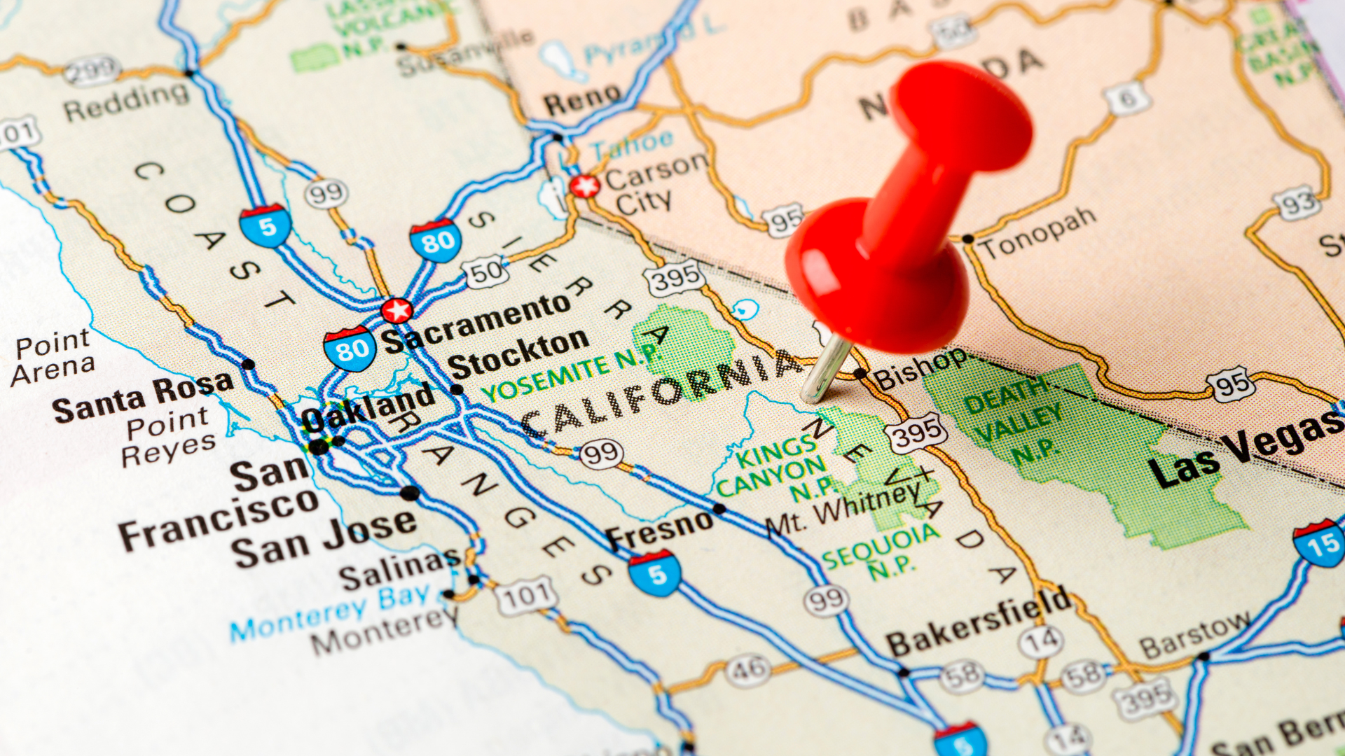 A red pushpin marks a location on a map of California, positioned east of the San Francisco Bay area near Yosemite.