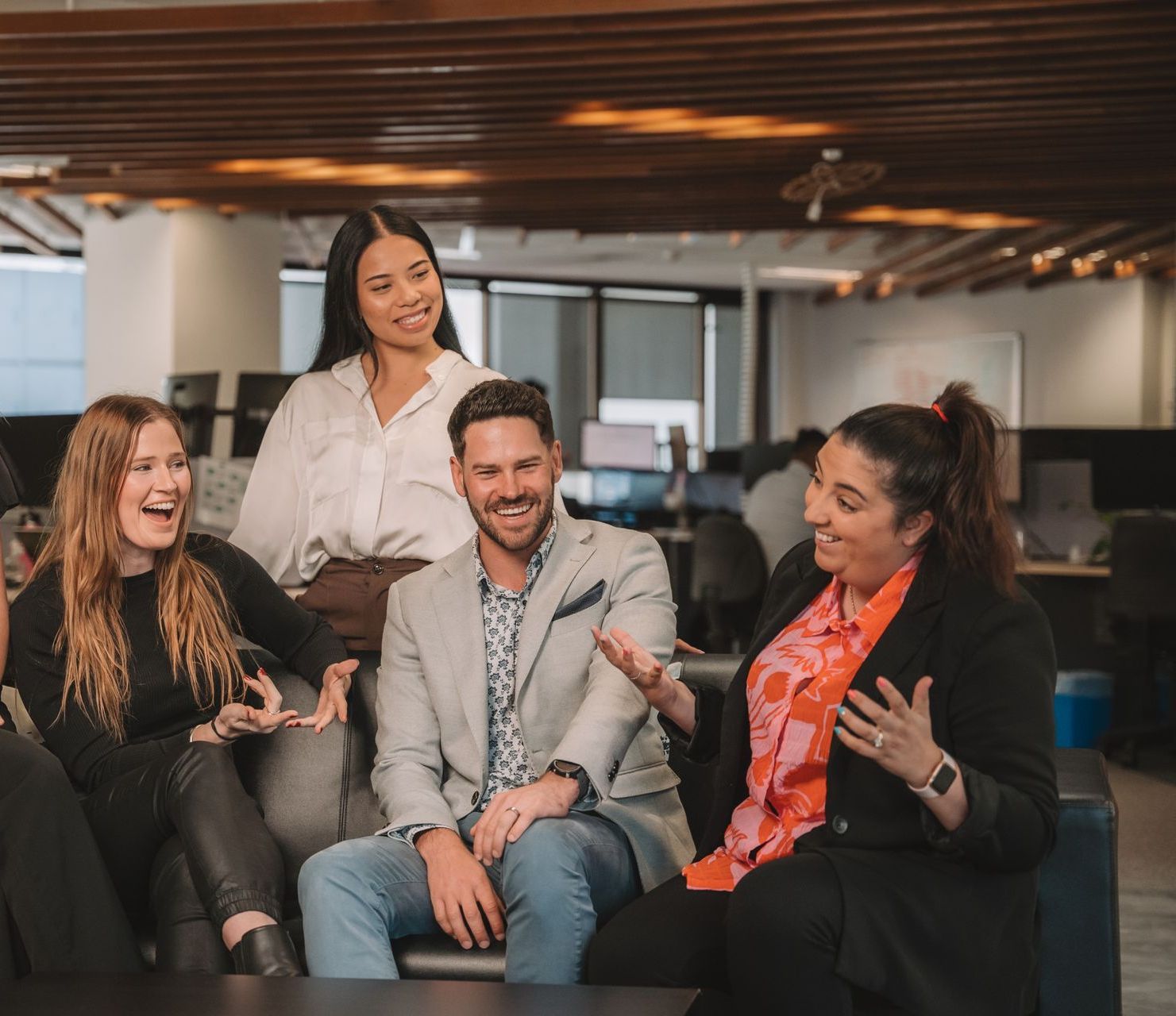 Group of Stellar Recruitment team laughing together on a couch.